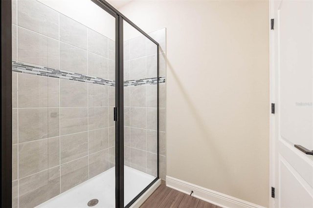 bathroom with hardwood / wood-style floors and walk in shower