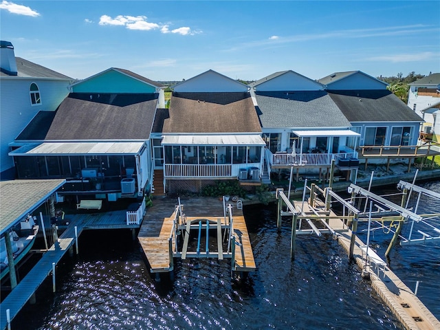 back of house with a water view and a sunroom