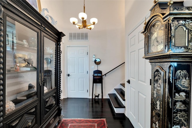 foyer entrance with a notable chandelier and dark hardwood / wood-style flooring