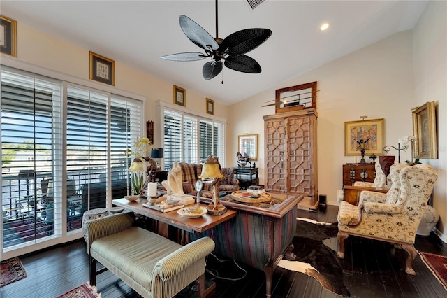 living room featuring lofted ceiling, dark hardwood / wood-style floors, ceiling fan, and a wealth of natural light