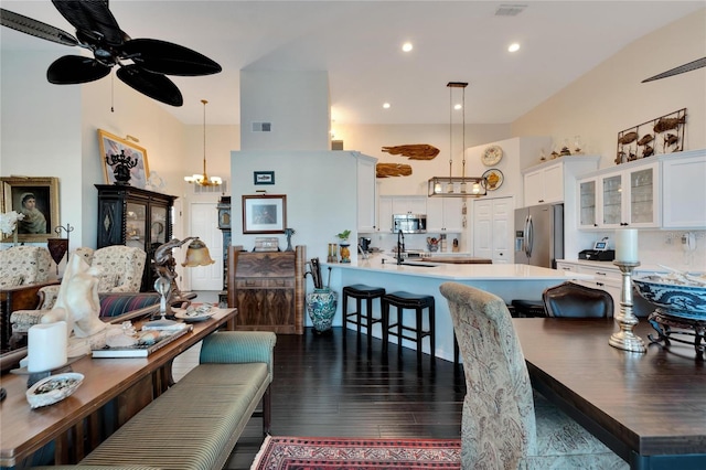 living room featuring dark hardwood / wood-style floors and ceiling fan with notable chandelier