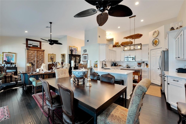 dining space featuring sink, ceiling fan, high vaulted ceiling, and dark hardwood / wood-style flooring