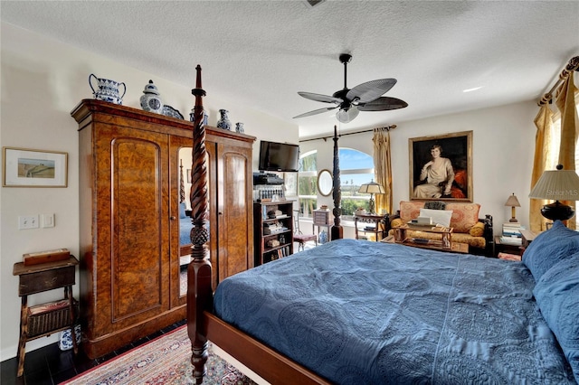 bedroom with a textured ceiling and ceiling fan