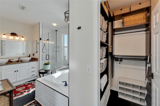 bathroom featuring vanity and shower with separate bathtub