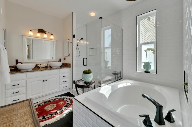 bathroom featuring vanity and plus walk in shower