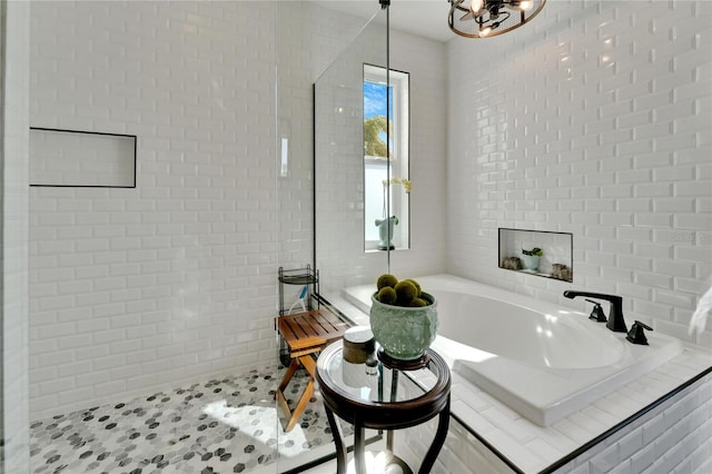 bathroom featuring tile patterned floors and tiled bath