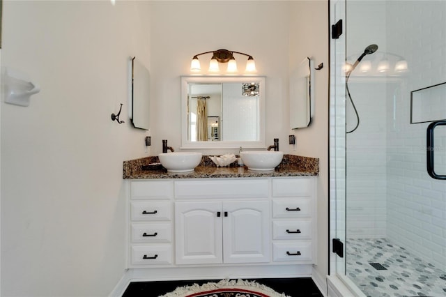 bathroom with vanity and a shower with shower door