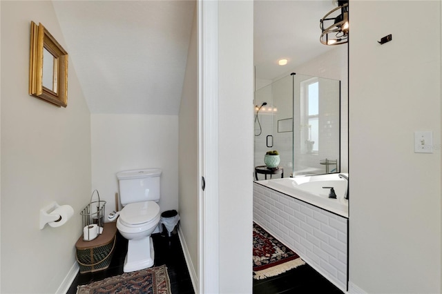 bathroom featuring toilet, lofted ceiling, and separate shower and tub