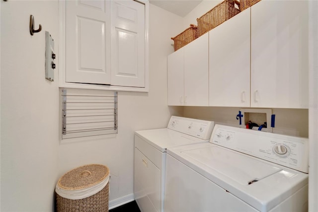 laundry room with cabinets and washer and clothes dryer