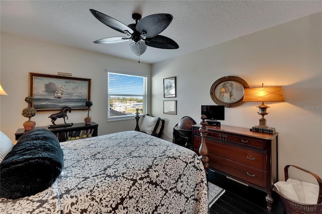 bedroom with a textured ceiling and ceiling fan