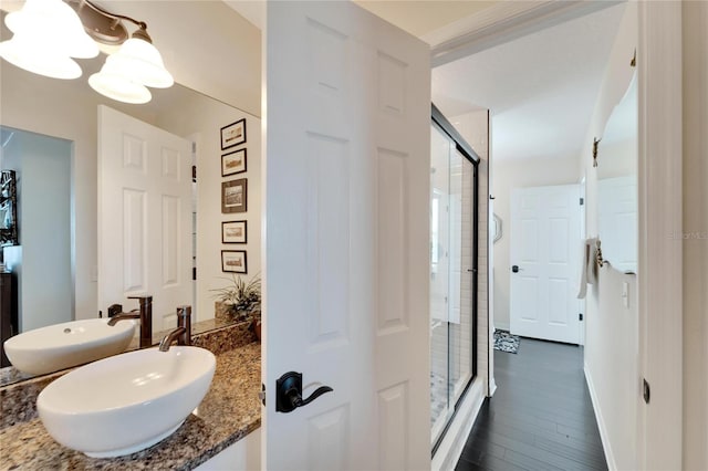 bathroom featuring vanity, an enclosed shower, and hardwood / wood-style floors