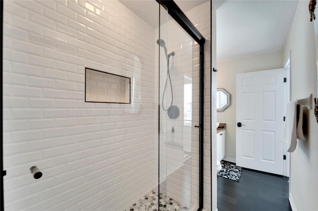 bathroom with hardwood / wood-style floors and walk in shower