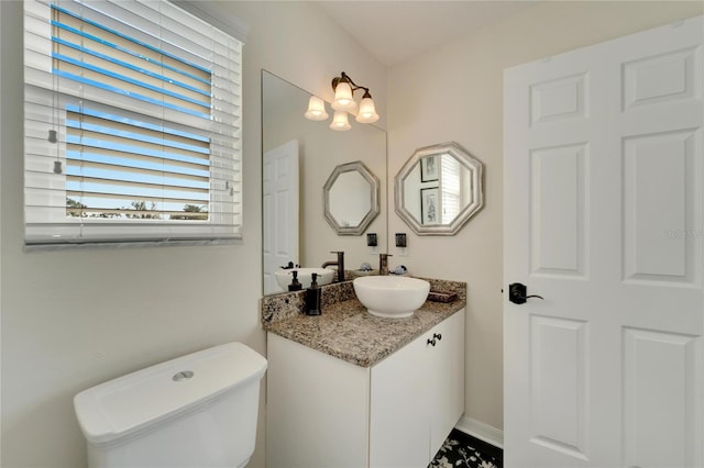 bathroom with vanity and toilet