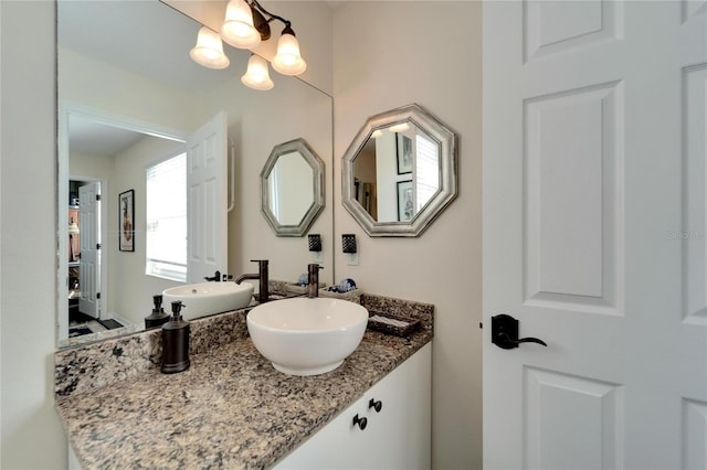 bathroom with vanity and a chandelier