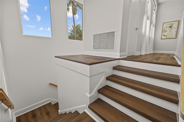 stairs featuring wood-type flooring