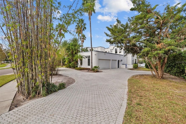 view of front of property featuring a garage and a front yard