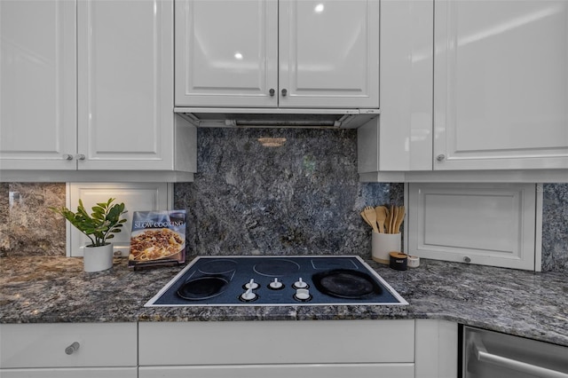 kitchen with tasteful backsplash, white cabinetry, black electric cooktop, and range hood