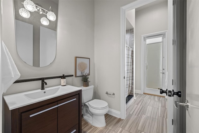 bathroom featuring vanity, toilet, and a shower with shower curtain