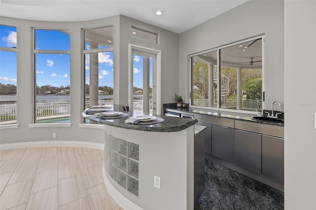 kitchen with a water view and sink