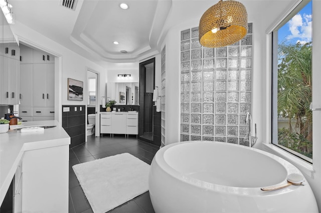 full bathroom with tile walls, tile patterned flooring, vanity, a notable chandelier, and separate shower and tub