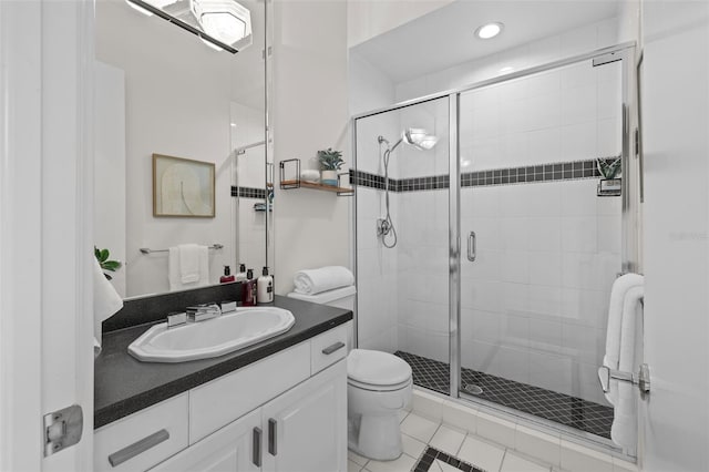 bathroom featuring vanity, toilet, and an enclosed shower