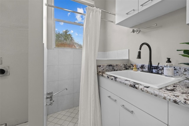 bathroom featuring tile patterned flooring, vanity, and a shower with shower curtain