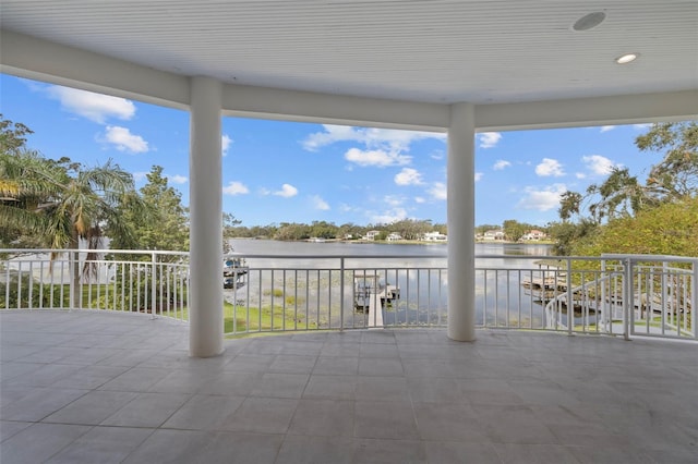 view of patio with a balcony and a water view