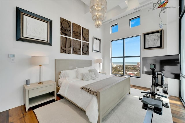 bedroom featuring light hardwood / wood-style flooring and an inviting chandelier