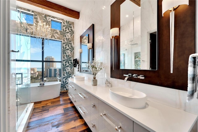 bathroom with hardwood / wood-style flooring, vanity, beam ceiling, and shower with separate bathtub