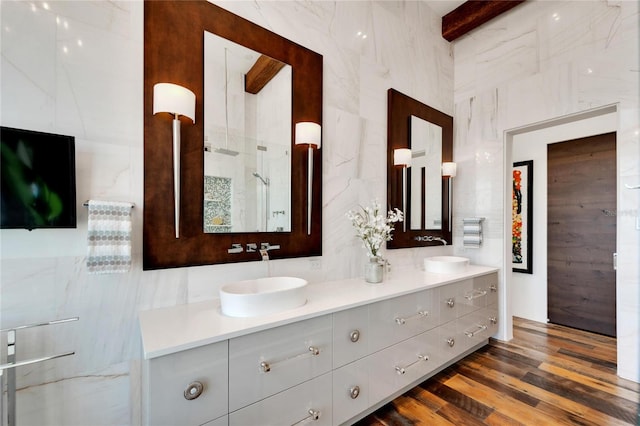 bathroom with hardwood / wood-style floors, vanity, a shower, tile walls, and beamed ceiling