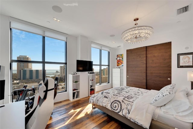 bedroom featuring hardwood / wood-style flooring and a chandelier