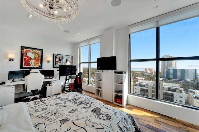 bedroom with hardwood / wood-style flooring and a chandelier