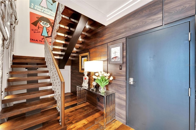 entrance foyer featuring wood walls and hardwood / wood-style floors