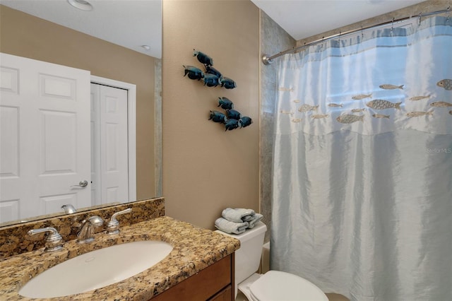 bathroom with vanity, a shower with shower curtain, and toilet
