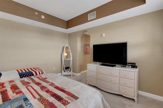 bedroom featuring light carpet