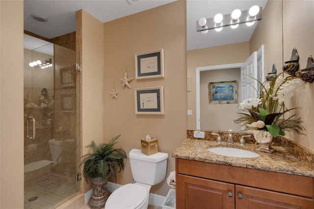 bathroom with vanity, a notable chandelier, toilet, and walk in shower