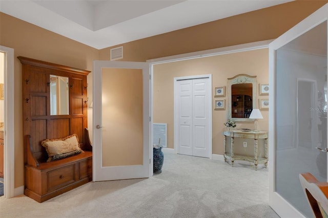 hallway with light colored carpet