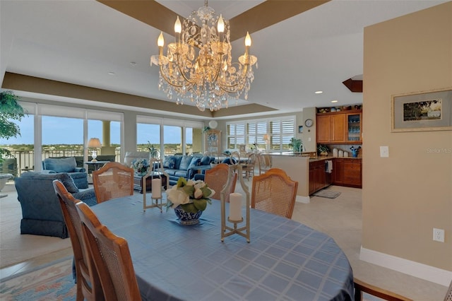 dining area with light tile patterned floors and a chandelier