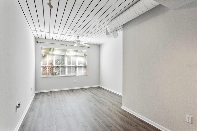 unfurnished room with hardwood / wood-style flooring and ceiling fan