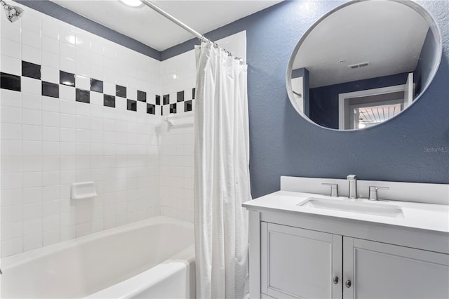 bathroom featuring shower / bath combo with shower curtain and vanity