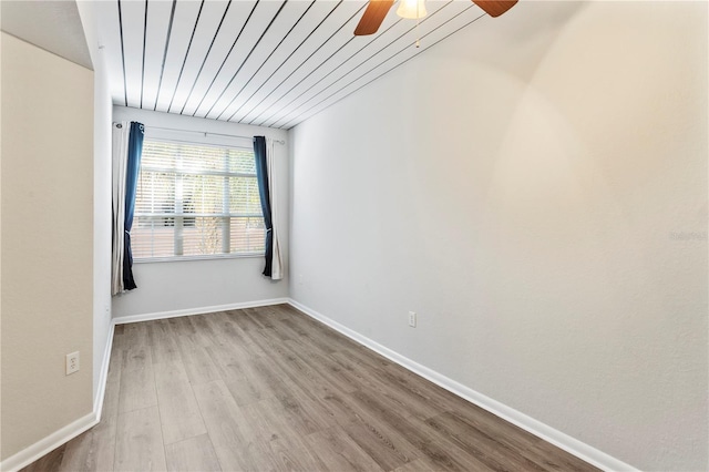 spare room with ceiling fan and light wood-type flooring