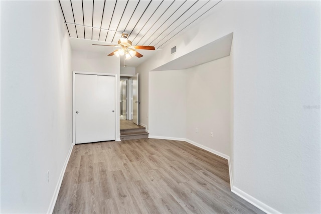 spare room with light wood-type flooring and ceiling fan