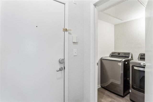 washroom featuring washer and dryer and light wood-type flooring