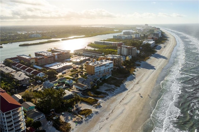 bird's eye view featuring a water view and a beach view