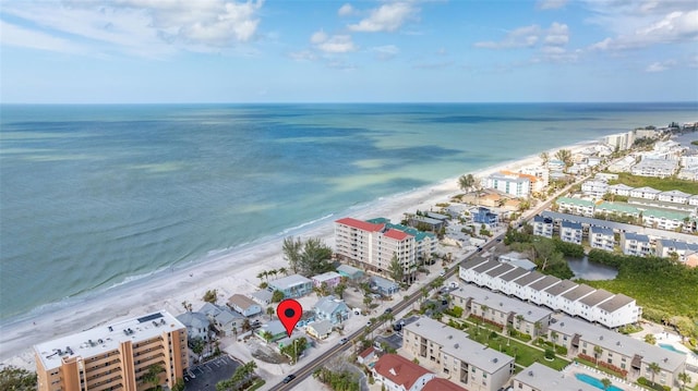 drone / aerial view featuring a water view and a view of the beach