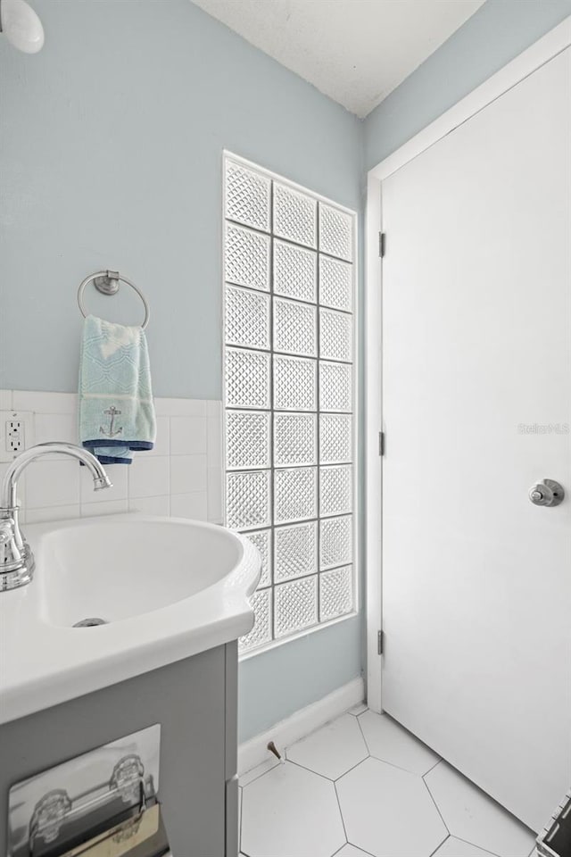 bathroom featuring tile patterned floors, vanity, and a wealth of natural light