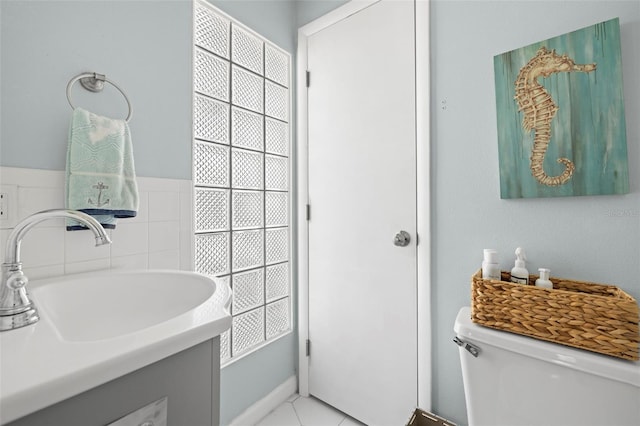 bathroom featuring tile patterned flooring, vanity, and toilet