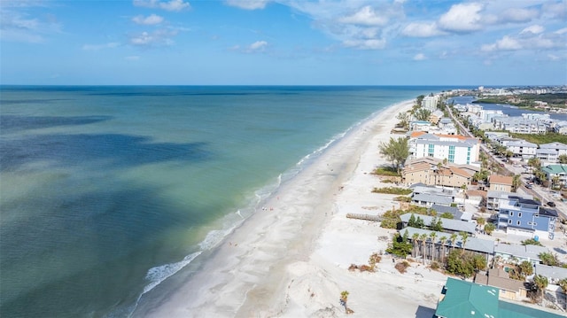 birds eye view of property featuring a beach view and a water view