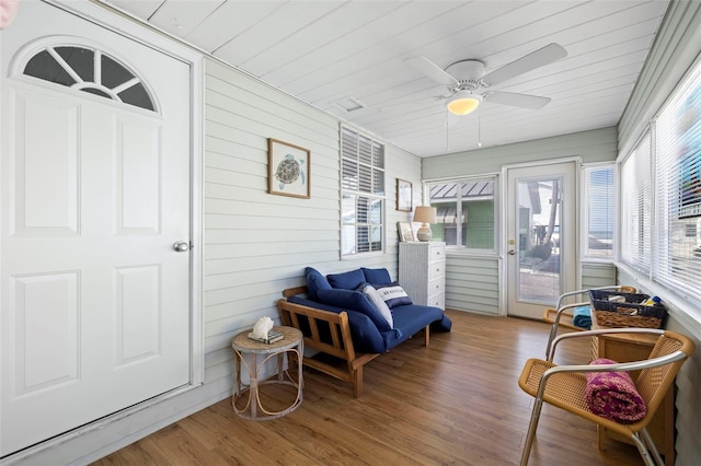 sunroom featuring ceiling fan and wood ceiling