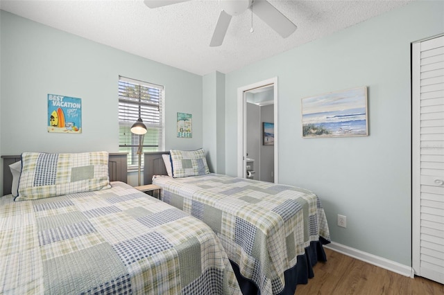 bedroom with wood-type flooring, a textured ceiling, and ceiling fan